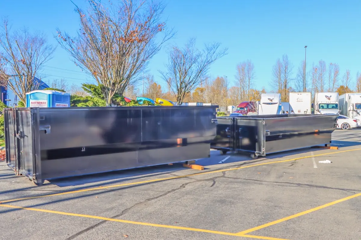 Professional dumpster rental service with roll-off container on residential driveway in Bushkill